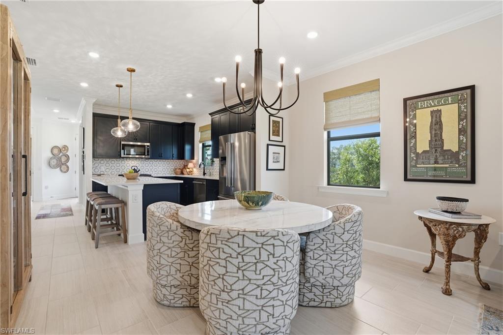 1955 Sierra Court Naples, FL 34120 - Photo 2 of 50 a room with stainless steel appliances kitchen island granite countertop a stove a sink a dining table and chairs