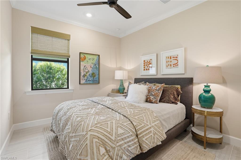 1955 Sierra Court Naples, FL 34120 - Photo 21 of 50 a bed sitting in a bedroom next to a window