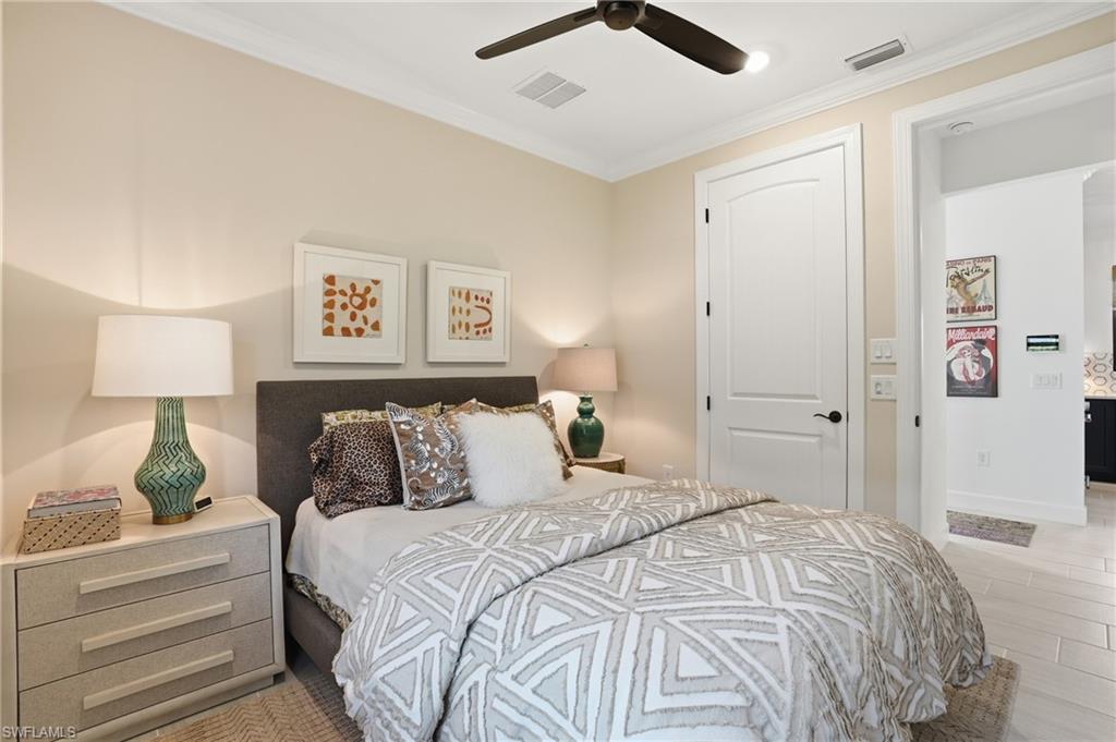 1955 Sierra Court Naples, FL 34120 - Photo 22 of 50 a bedroom with a bed and a lamp
