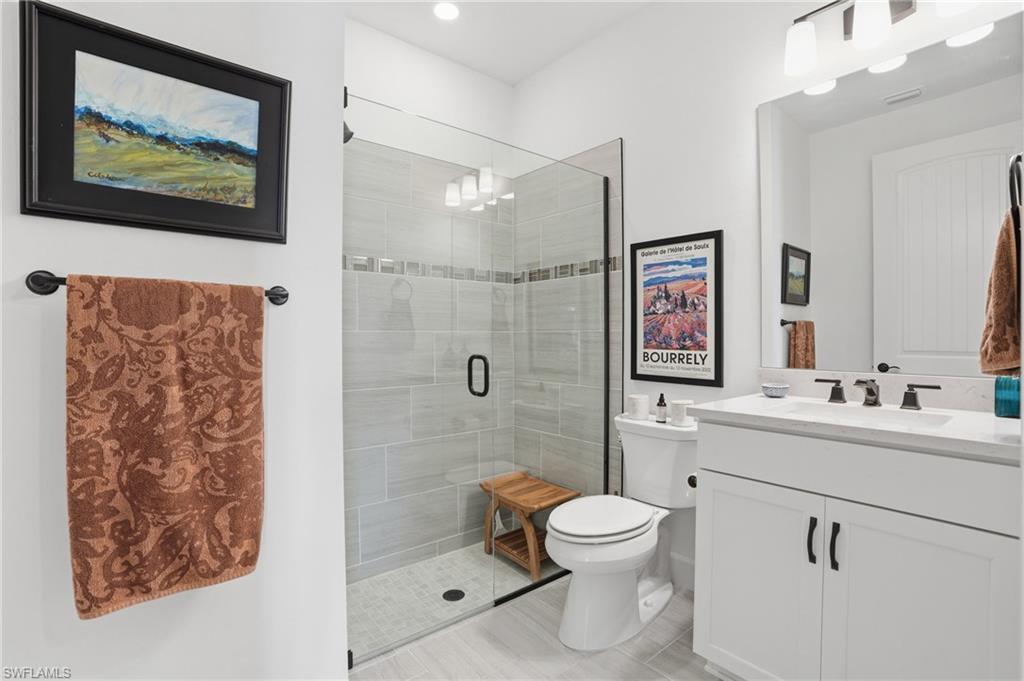 1955 Sierra Court Naples, FL 34120 - Photo 23 of 50 a bathroom with a toilet sink and mirror