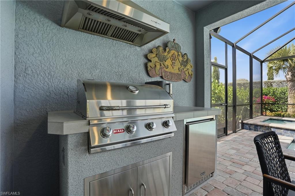 1955 Sierra Court Naples, FL 34120 - Photo 27 of 50 a kitchen with stainless steel appliances granite countertop a stove and a sink