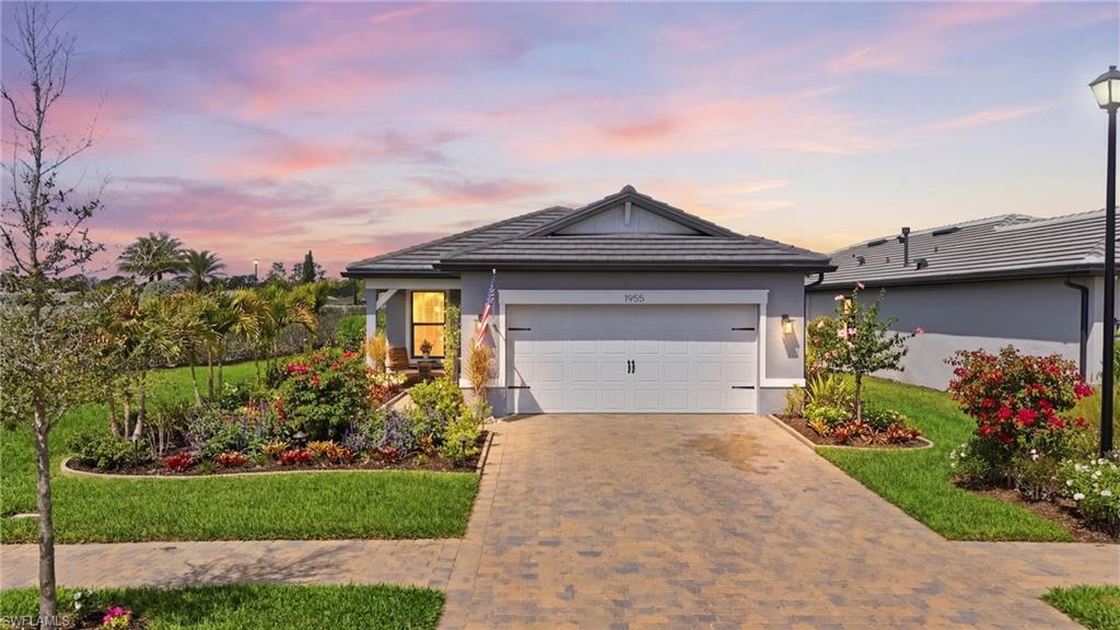 1955 Sierra Court Naples, FL 34120 - Photo 33 of 50 a front view of a house with a garden