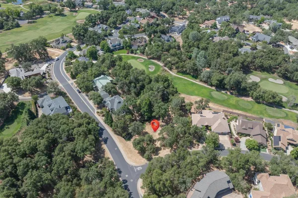 an aerial view of a house with a yard and lake view