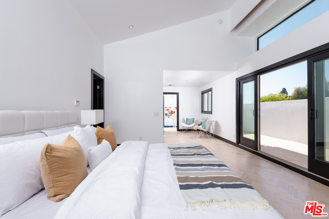 2663 Desmond Estates Road Los Angeles, CA 90046 - Photo 14 of 27 a bedroom with a large bed and a large window