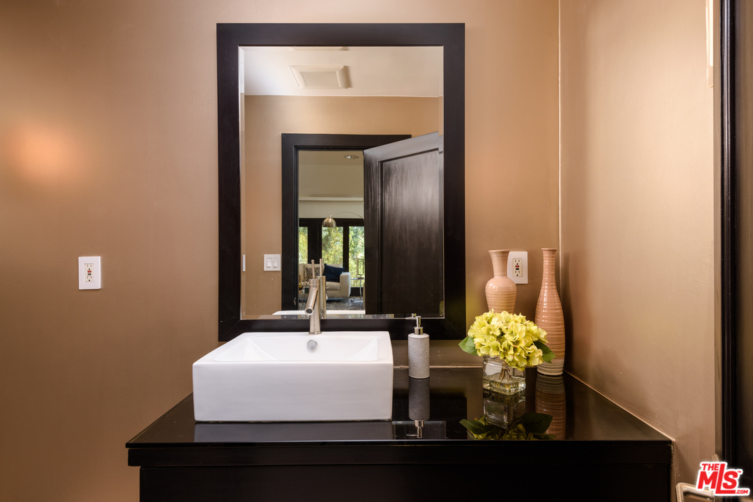 2663 Desmond Estates Road Los Angeles, CA 90046 - Photo 24 of 27 a bathroom with a sink vanity and a mirror