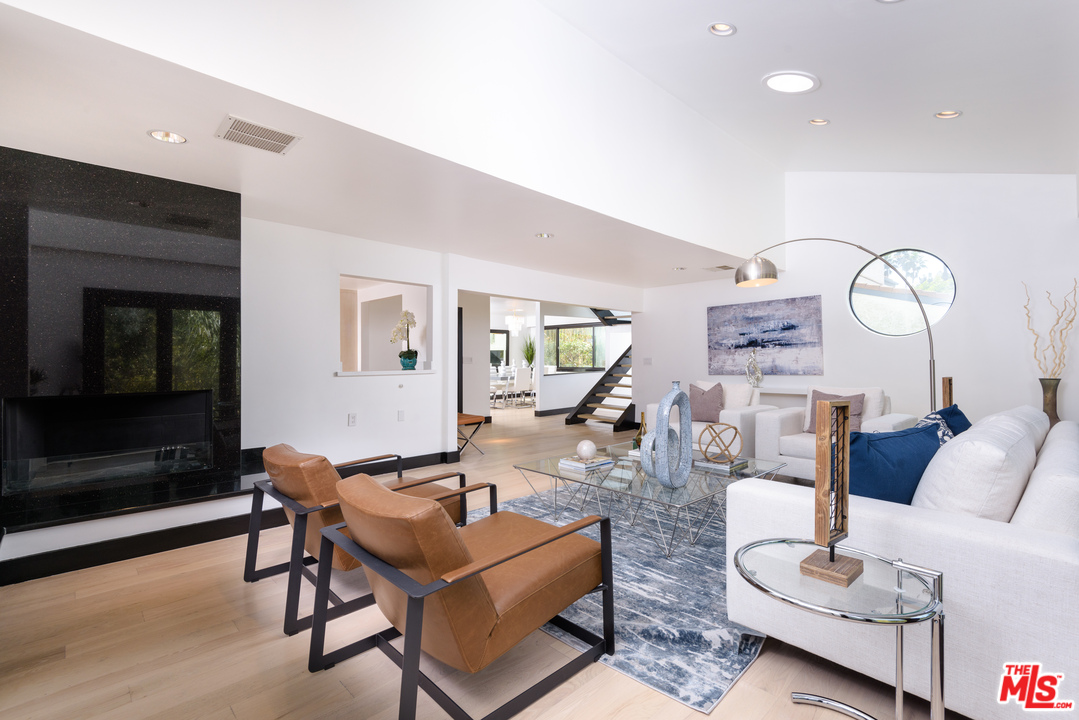 2663 Desmond Estates Road Los Angeles, CA 90046 - Photo 8 of 27 a living room with furniture a flat screen tv and a fireplace