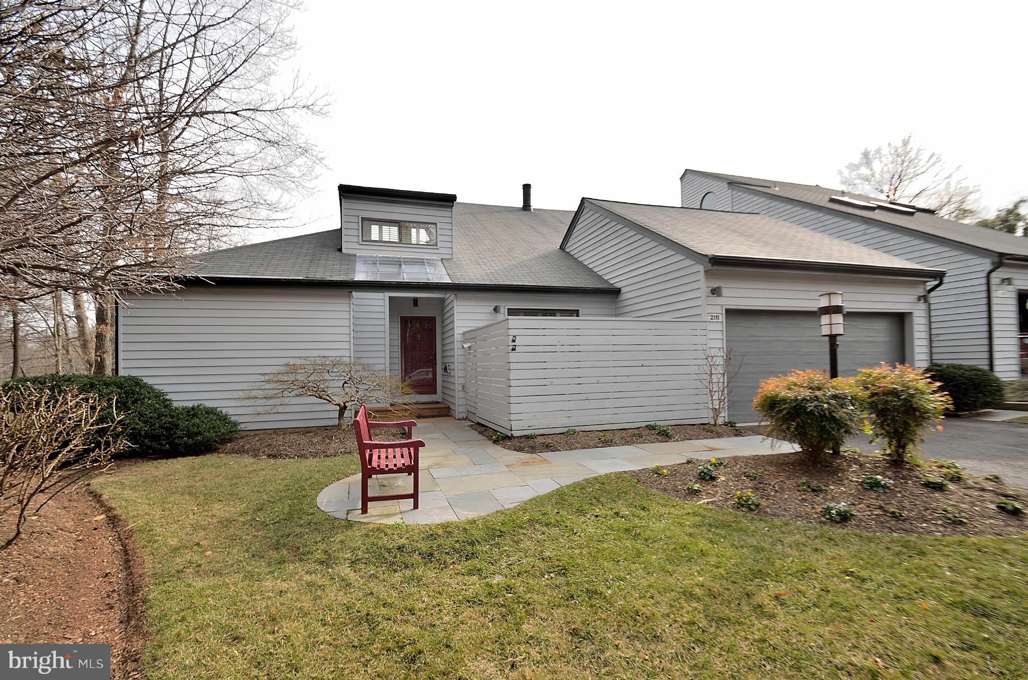 2111 South Bay Lane Reston, VA 20191 - Photo 1 of 30 a front view of a house with garden