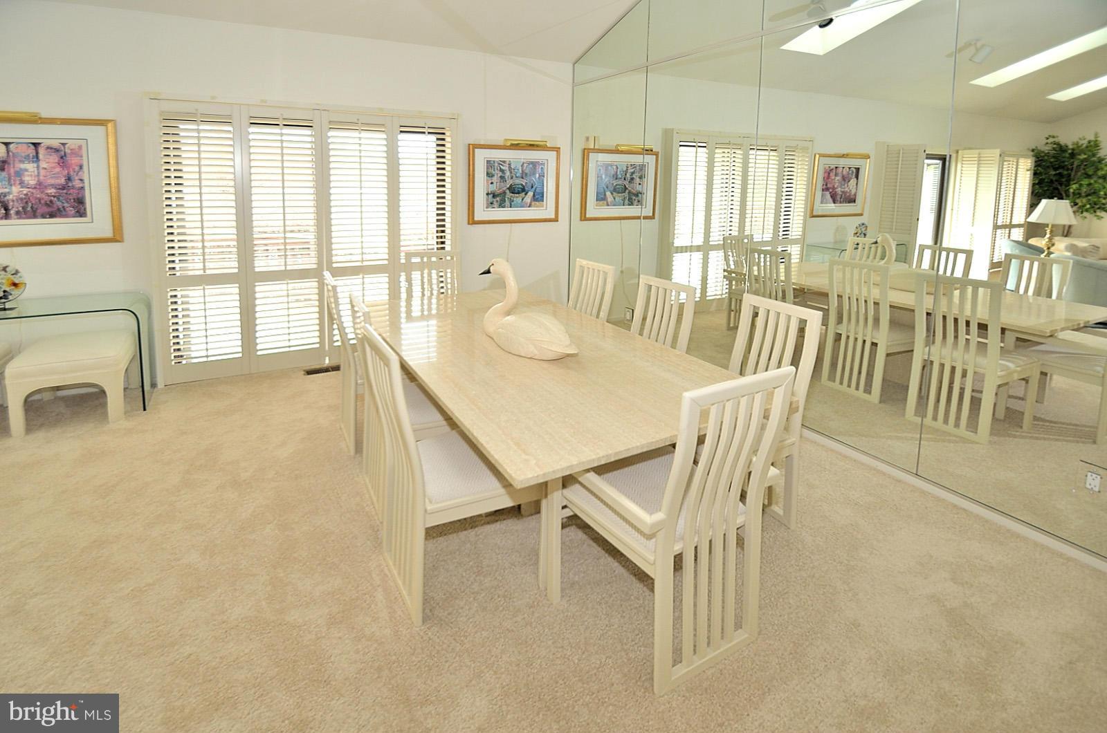 2111 South Bay Lane Reston, VA 20191 - Photo 8 of 30 a dining room with furniture and a floor to ceiling window