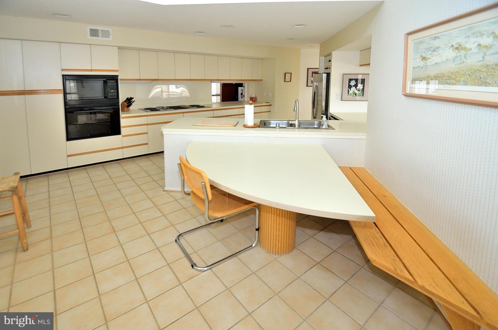 2111 South Bay Lane Reston, VA 20191 - Photo 10 of 30 a kitchen with stainless steel appliances a sink and a counter top space