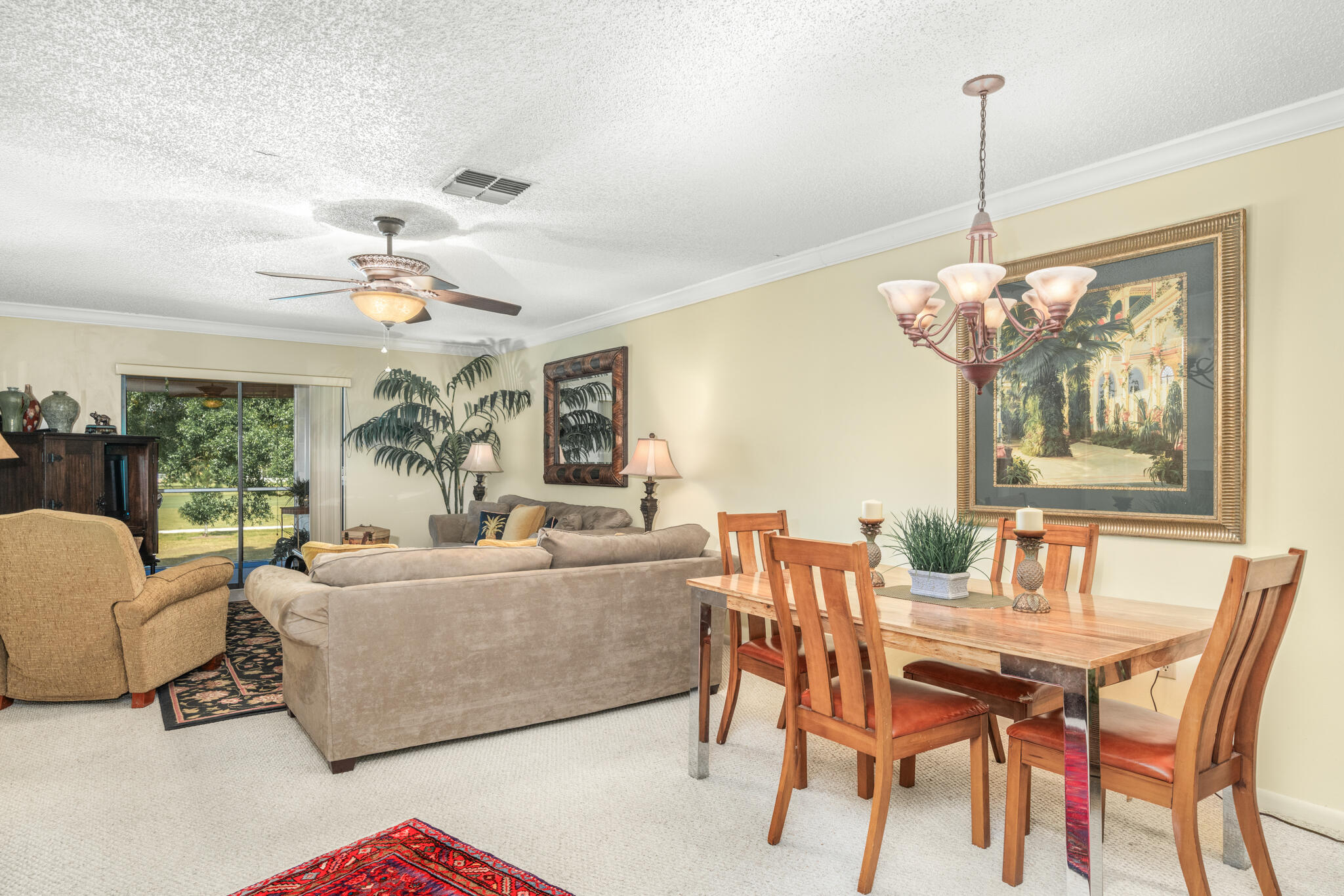 3833 Edgewater Drive Sebring, FL 33872 - Photo 8 of 51 a living room with furniture a chandelier and a table