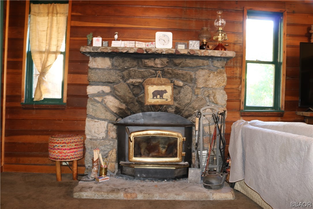 39372 Cedar Dell Road Fawnskin, CA 92333 - Photo 4 of 18 a fireplace with a clock on top of it