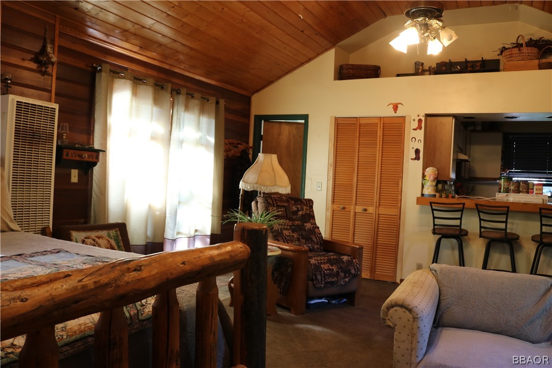 39372 Cedar Dell Road Fawnskin, CA 92333 - Photo 6 of 18 a bedroom with furniture and a flat screen tv