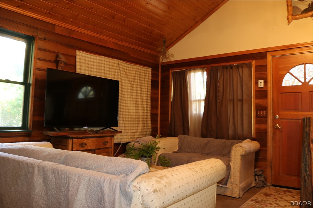 39372 Cedar Dell Road Fawnskin, CA 92333 - Photo 7 of 18 a living room with furniture and a flat screen tv