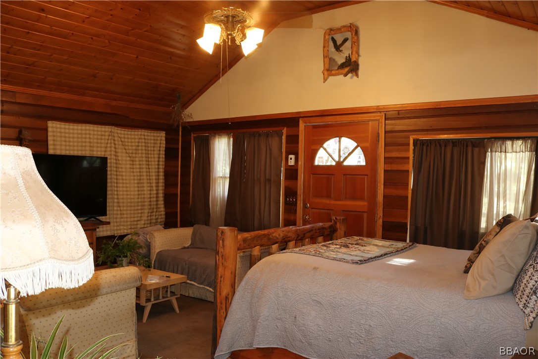 39372 Cedar Dell Road Fawnskin, CA 92333 - Photo 9 of 18 a bedroom with a bed a dresser and mirror