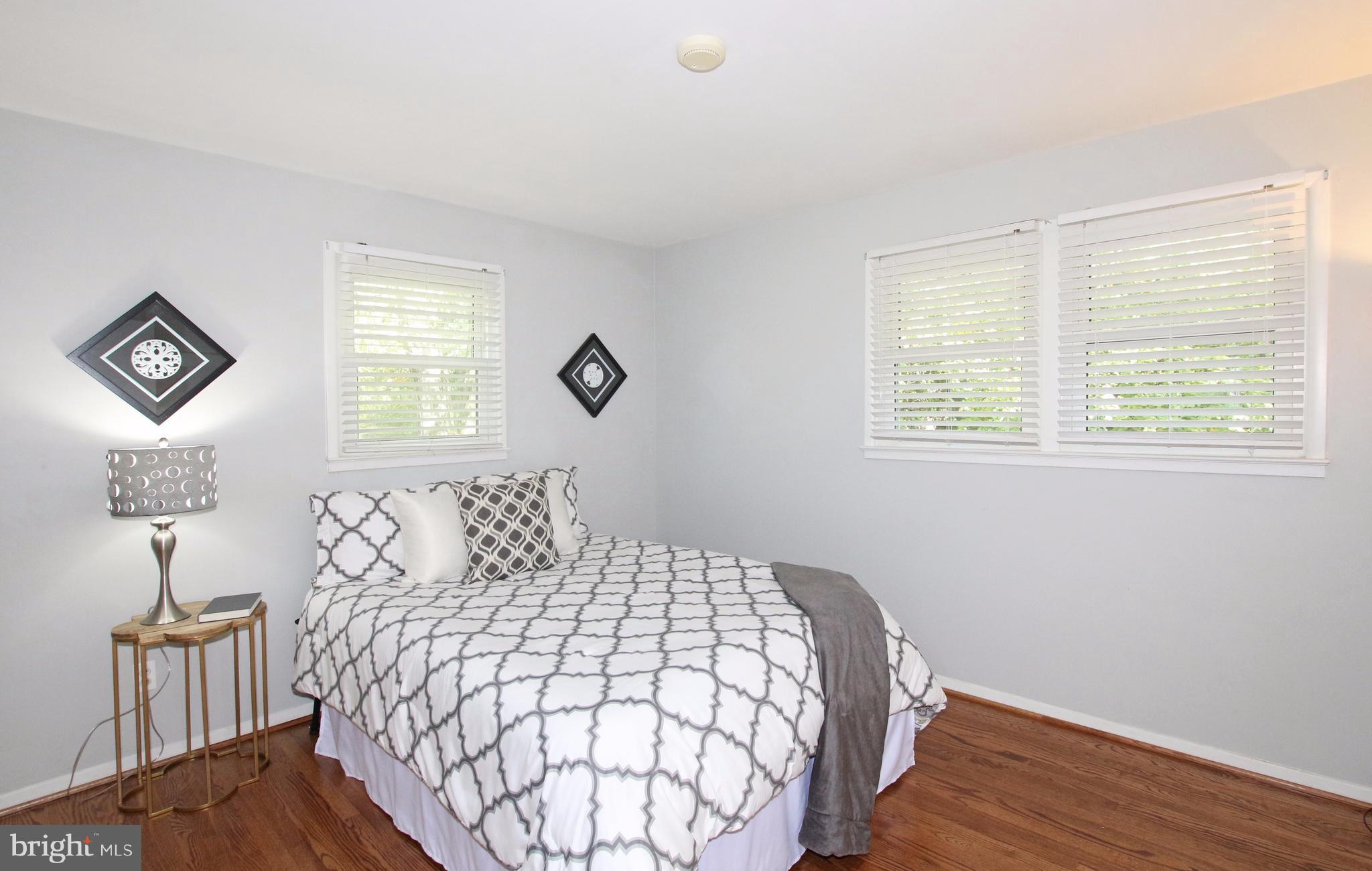 5300 Ravensworth Road Springfield, VA 22151 - Photo 17 of 28 a bedroom with a bed and wooden floor
