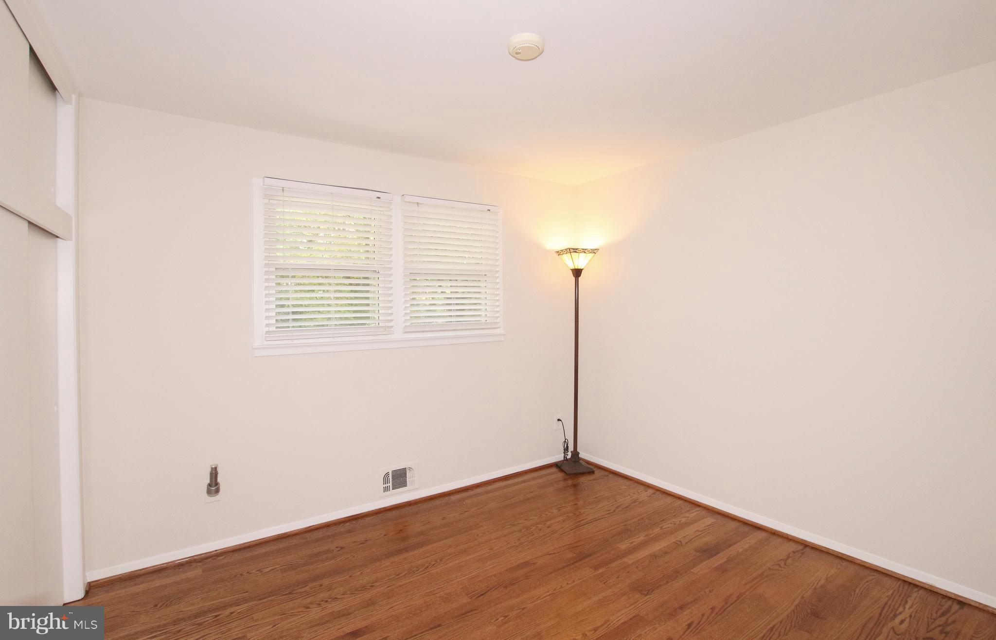 5300 Ravensworth Road Springfield, VA 22151 - Photo 18 of 28 an empty room with wooden floor and windows