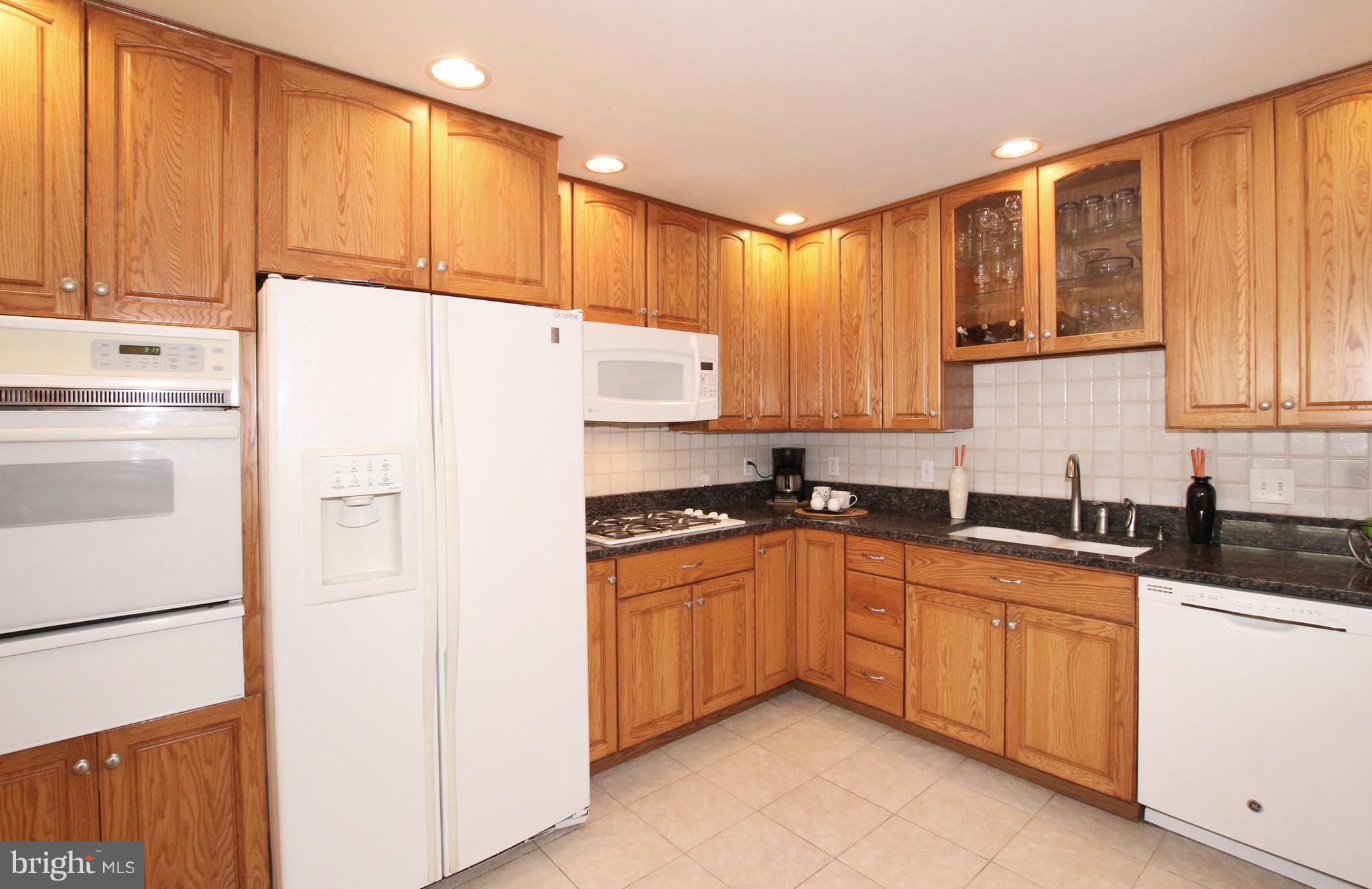5300 Ravensworth Road Springfield, VA 22151 - Photo 3 of 28 a white refrigerator freezer sitting in a kitchen
