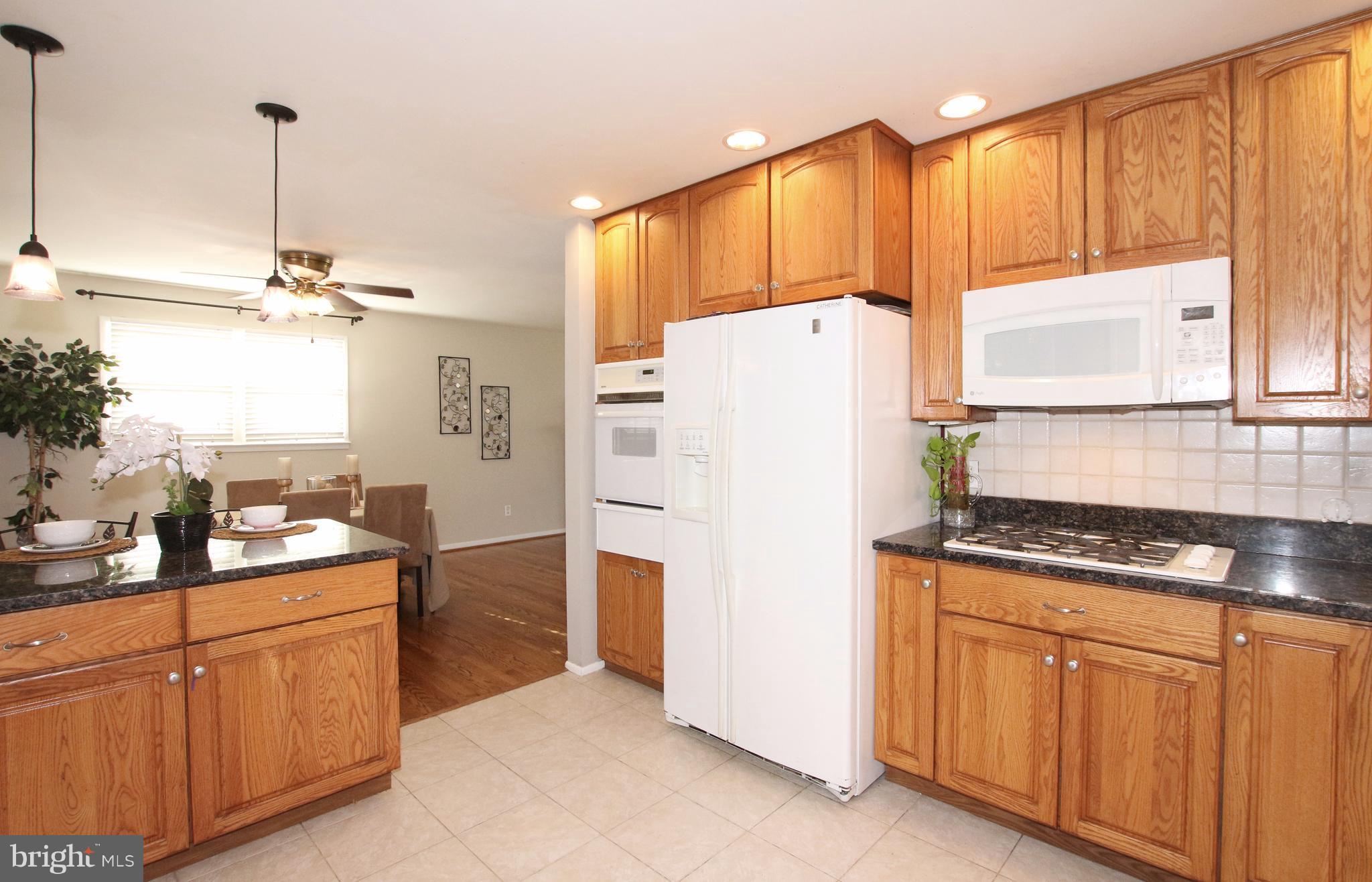 5300 Ravensworth Road Springfield, VA 22151 - Photo 4 of 28 a kitchen with stainless steel appliances a refrigerator sink and cabinets