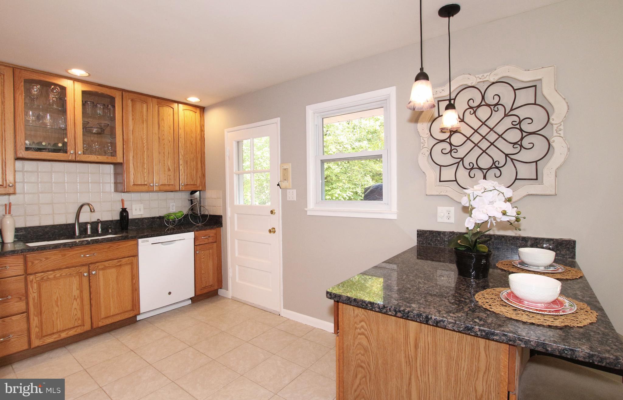 5300 Ravensworth Road Springfield, VA 22151 - Photo 5 of 28 a kitchen with stainless steel appliances granite countertop a sink a stove and a wooden floors