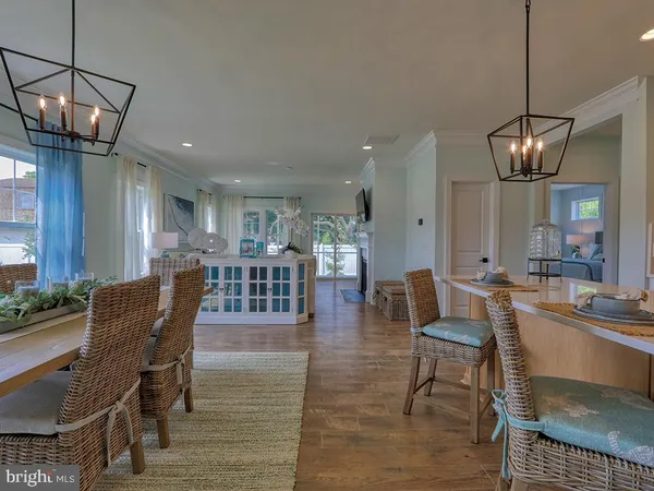 a dining room with furniture a chandelier and wooden floor