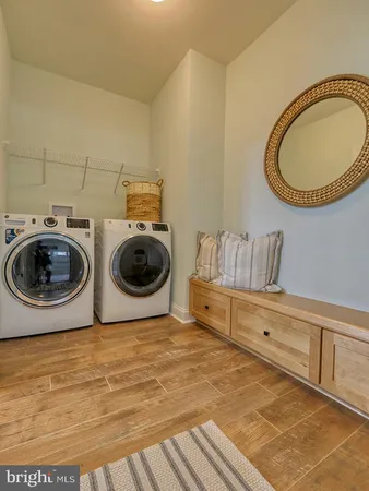 a utility room with sink dryer and washer