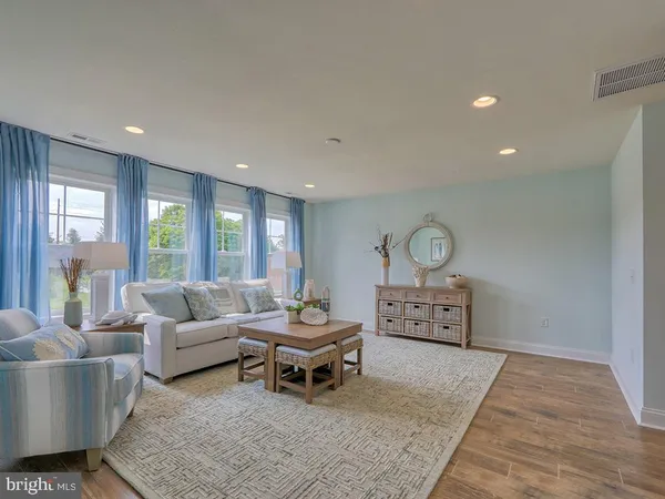 a living room with furniture a rug and a large window