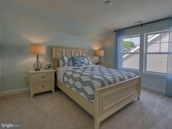 a bedroom with a bed and a night stand