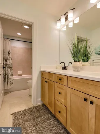 a bathroom with a sink a mirror and a shower