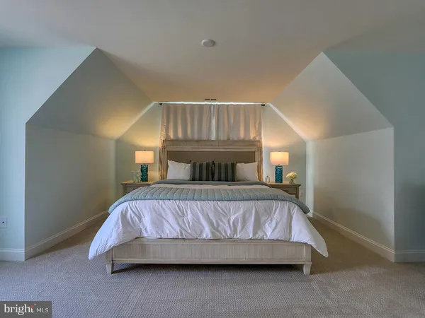 a bed sitting in a bedroom next to a window