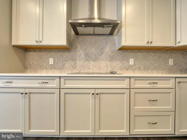 a kitchen with granite countertop white cabinets and a stainless steel appliances