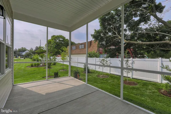 a view of a backyard and floor to ceiling window