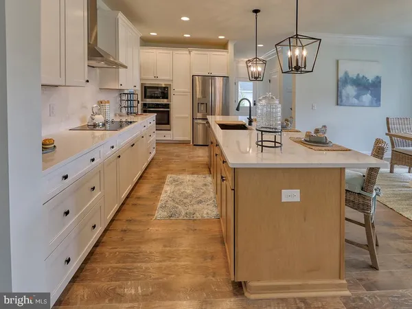 a kitchen with stainless steel appliances granite countertop a sink a stove and a refrigerator