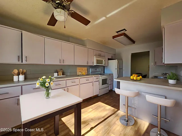 a kitchen with a sink a counter space and appliances