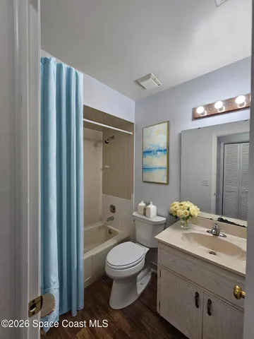 a bathroom with a granite countertop sink toilet a large mirror a shower and a bathtub