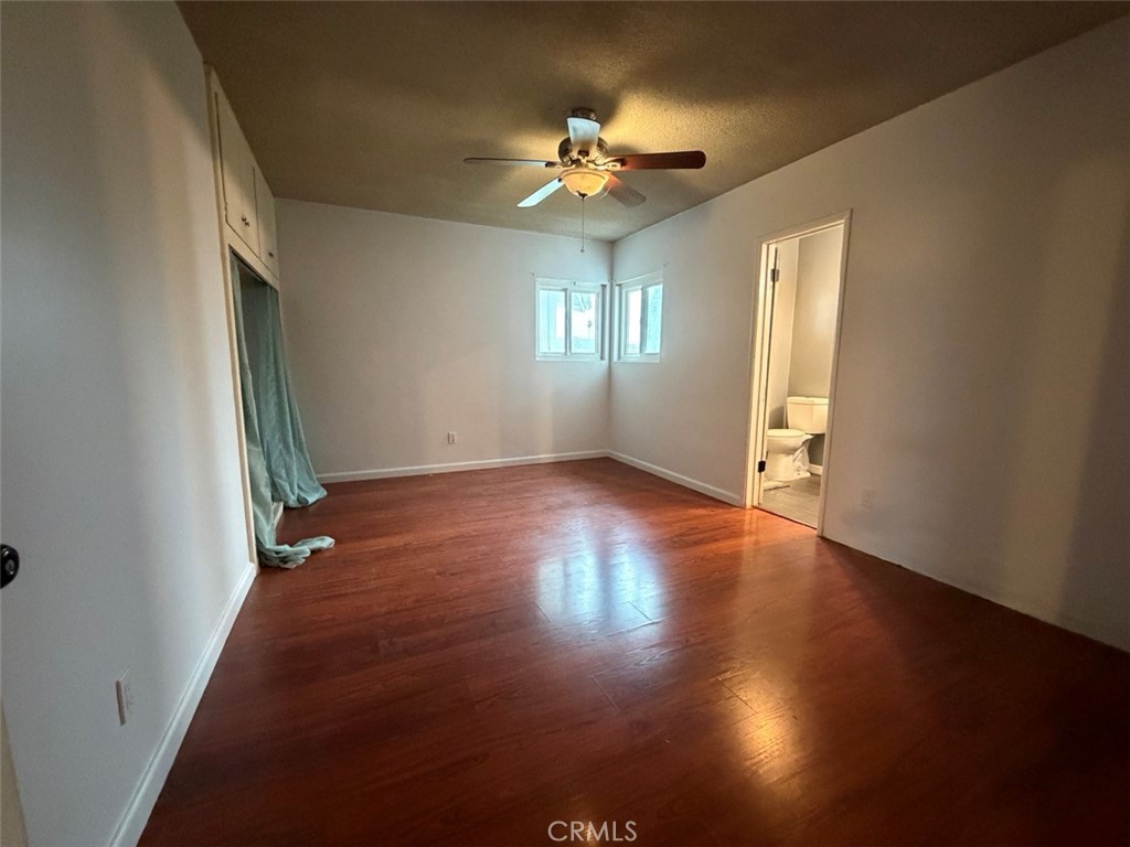 22706 Rashdall Avenue Carson, CA 90745 - Photo 13 of 32 an empty room with wooden floor and windows