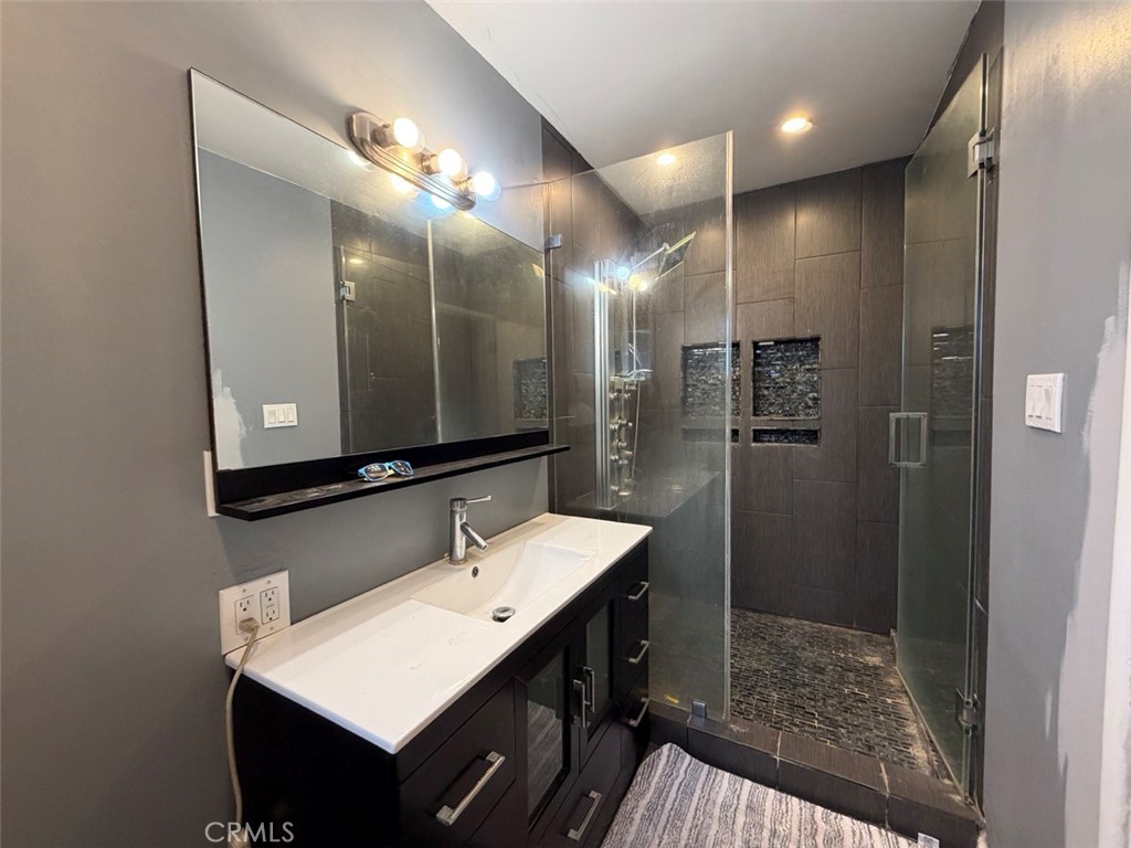22706 Rashdall Avenue Carson, CA 90745 - Photo 15 of 32 a bathroom with a sink a shower a mirror and a toilet