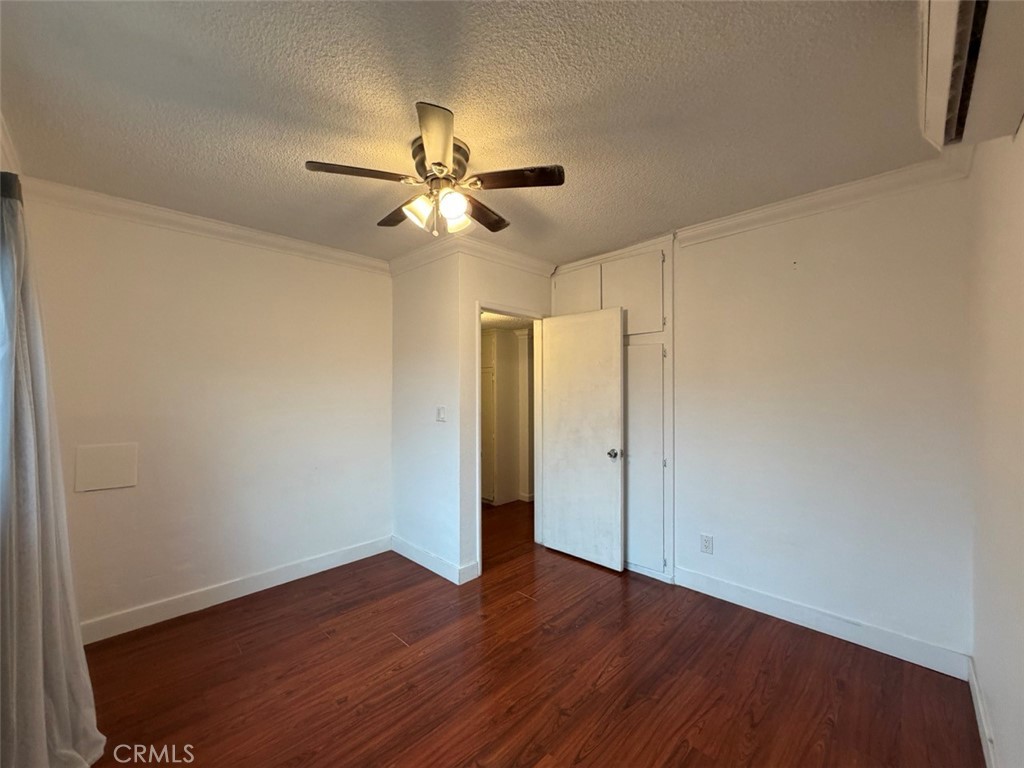 22706 Rashdall Avenue Carson, CA 90745 - Photo 19 of 32 an empty room with wooden floor fan and windows