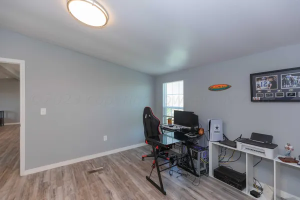a view of workspace with wooden floor windows