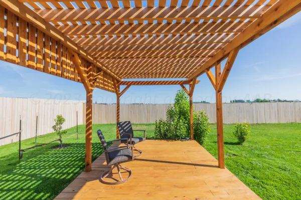 a backyard of a house with plants and outdoor seating