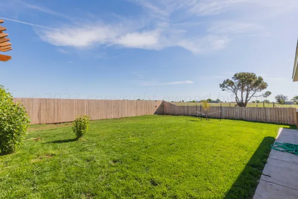 a view of a field with an trees in the background