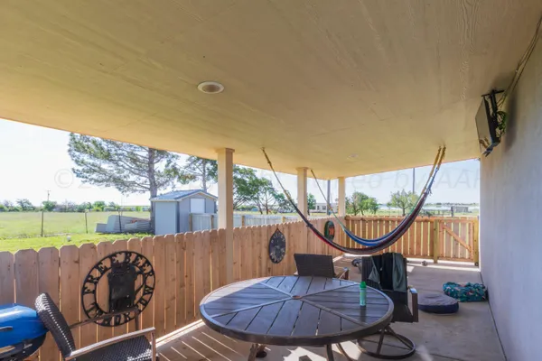 a view of a two chairs in the patio