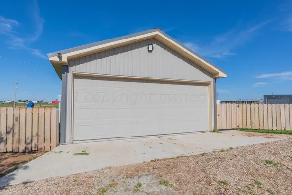a front view of a house with a wooden fence