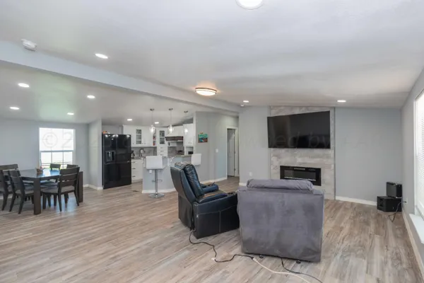 a living room with furniture wooden floor and a flat screen tv