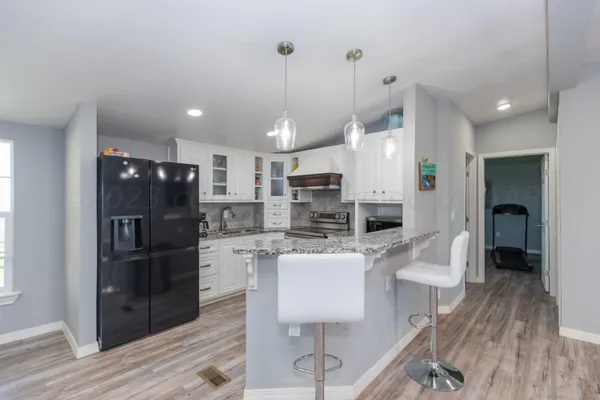 a large kitchen with a table and chairs
