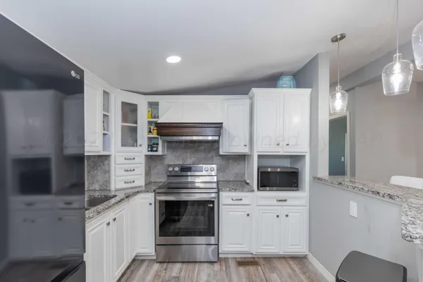 a kitchen with a stove and a refrigerator