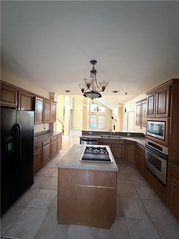 5214 Spring Brook Drive Corpus Christi, TX 78413 - Photo 5 of 12 a kitchen with stainless steel appliances a stove a sink and a refrigerator