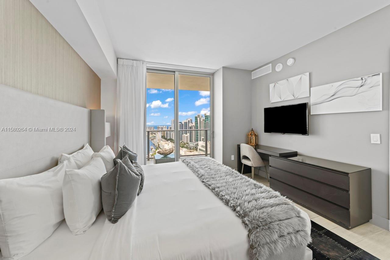 4010 South Ocean Drive, Unit R3001 Hollywood, FL 33019 - Photo 22 of 44 a living room with furniture and a flat screen tv