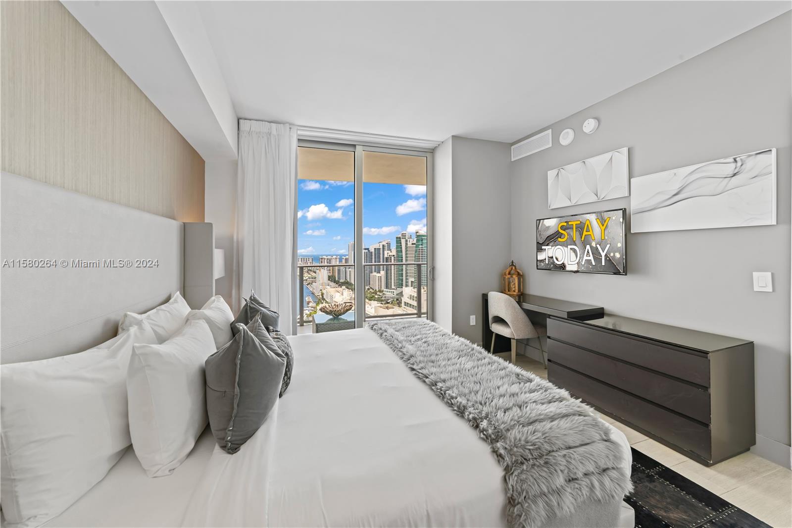 4010 South Ocean Drive, Unit R3001 Hollywood, FL 33019 - Photo 23 of 44 a spacious bedroom with a bed and window