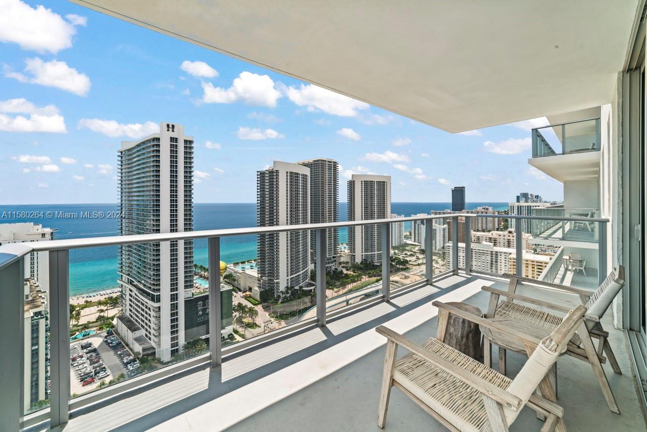 4010 South Ocean Drive, Unit R3001 Hollywood, FL 33019 - Photo 25 of 44 a view of a balcony with floor to ceiling windows and wooden floor
