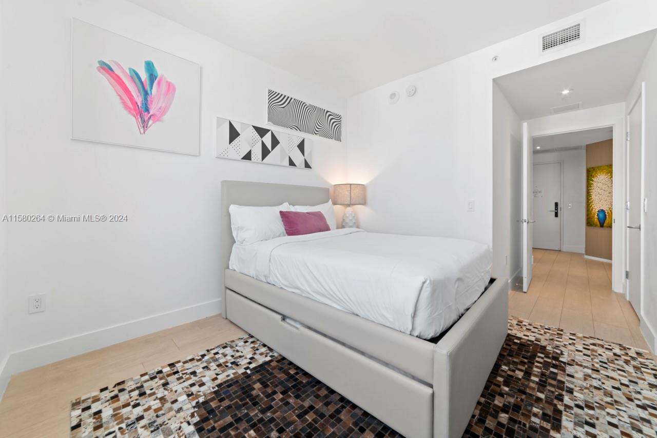 4010 South Ocean Drive, Unit R3001 Hollywood, FL 33019 - Photo 33 of 44 a bedroom with a bed and a cabinets